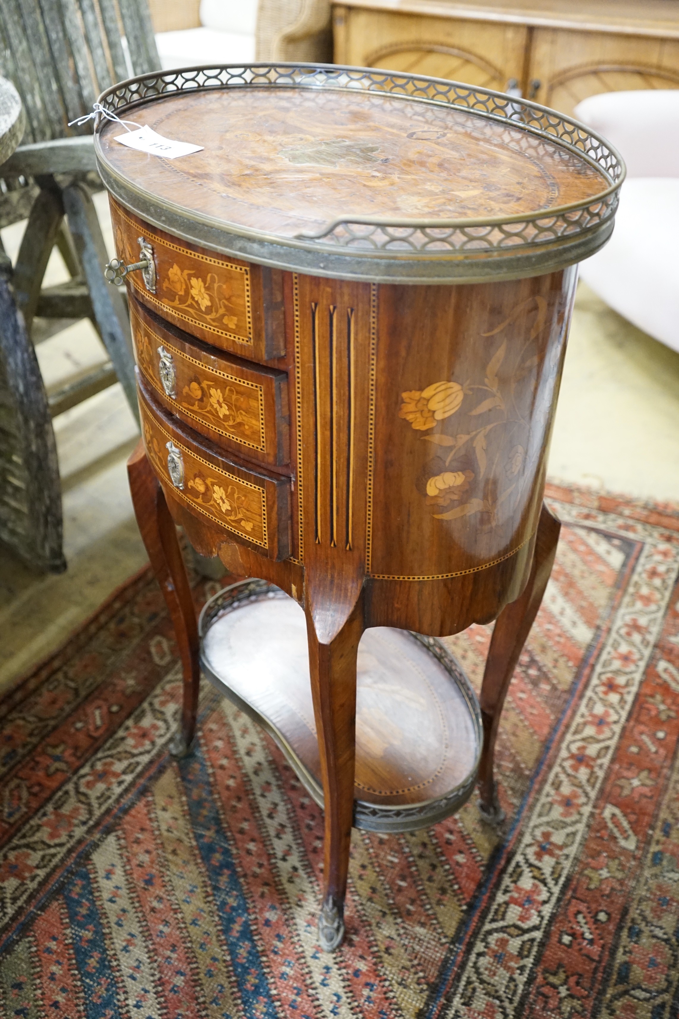 An early 20th century French marquetry oval three drawer small chest, width 50cm, depth 36cm, height 80cm